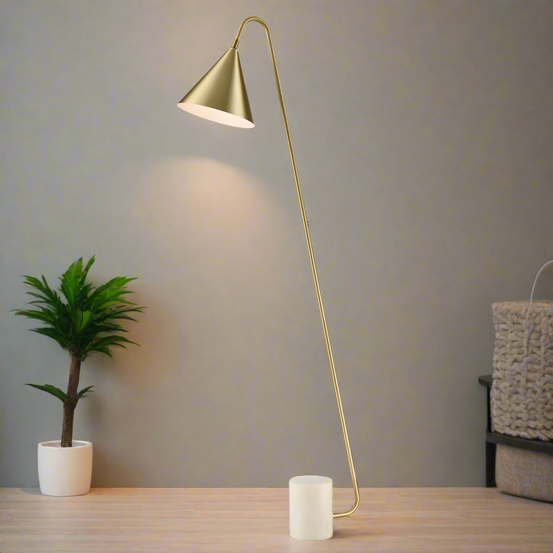 Stunning, stylish gilt metal floor lamp on a white marble base. The shade is satin brass with a white inner.&nbsp;&nbsp; A minimalist lamp perfect for a contemporary interior.&nbsp; The lamp is offset at an angle on a white marble plinth.&nbsp;