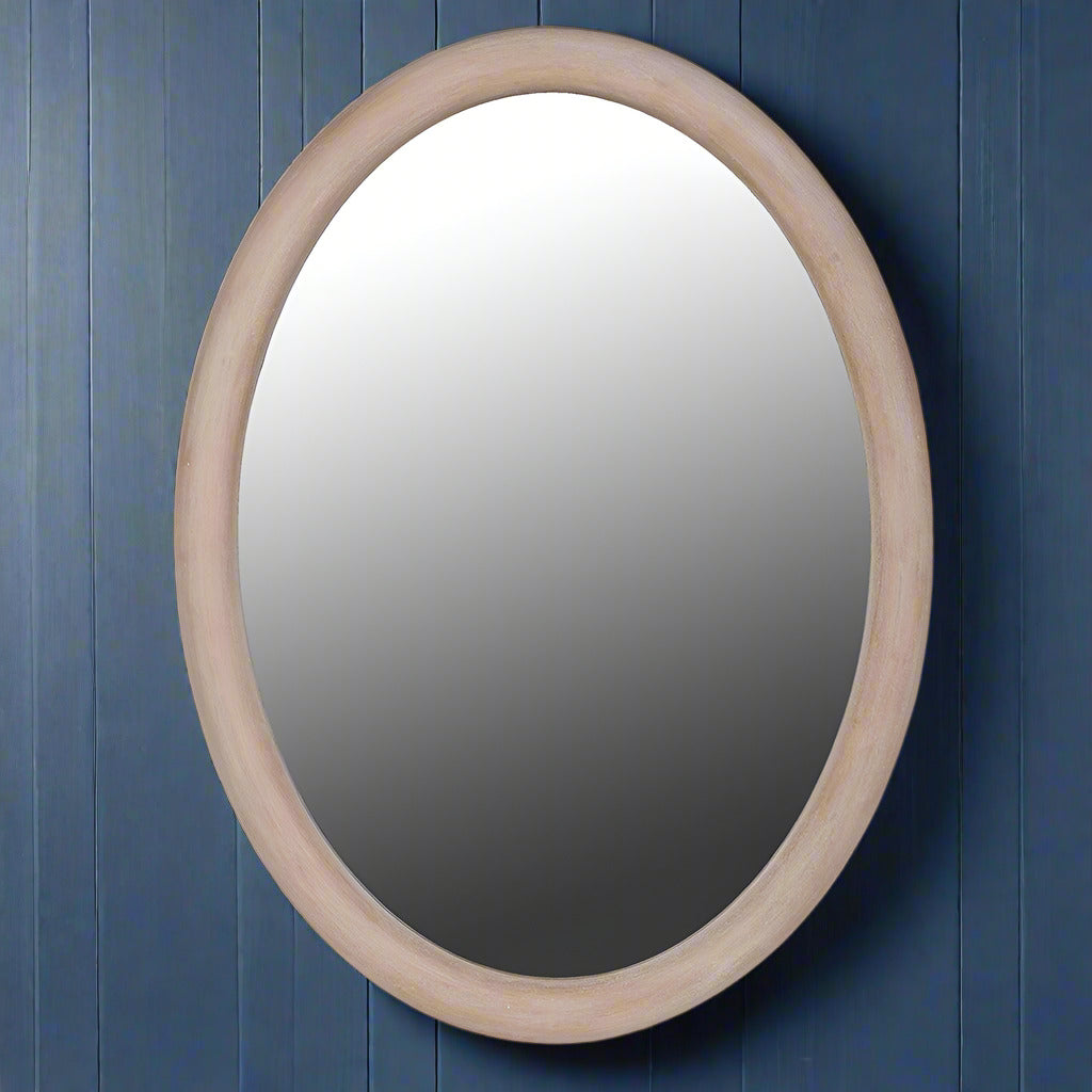 This Scandi-inspired oval wall mirror is designed with a smooth natural wood frame that adds warmth and minimal elegance to any room
