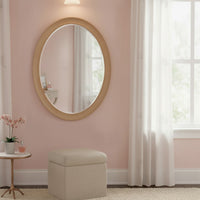 This Scandi-inspired oval wall mirror is designed with a smooth natural wood frame that adds warmth and minimal elegance to any room