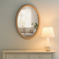 This Scandi-inspired oval wall mirror is designed with a smooth natural wood frame that adds warmth and minimal elegance to any room