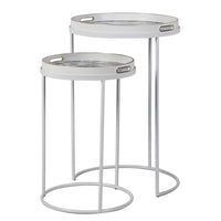A very unusual set of two side tables, one nested below the other, circular tables on a white metal frame.&nbsp; The trays, which are detachable and can be used independently, have a traditional blue and white willow pattern style print on them. They are set off with a gold rim to the edge of the trays which lifts them and gives them a luxurious look. They combine modern minimalism with a classic scenic decorative top. Perfect in a contemporary setting, a cottage or period home.&nbsp;