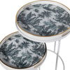 A very unusual set of two side tables, one nested below the other, circular tables on a white metal frame.&nbsp; The trays, which are detachable and can be used independently, have a traditional blue and white willow pattern style print on them. They are set off with a gold rim to the edge of the trays which lifts them and gives them a luxurious look. They combine modern minimalism with a classic scenic decorative top. Perfect in a contemporary setting, a cottage or period home.&nbsp;