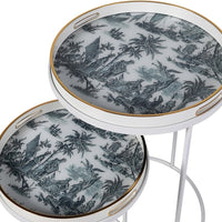 A very unusual set of two side tables, one nested below the other, circular tables on a white metal frame.&nbsp; The trays, which are detachable and can be used independently, have a traditional blue and white willow pattern style print on them. They are set off with a gold rim to the edge of the trays which lifts them and gives them a luxurious look. They combine modern minimalism with a classic scenic decorative top. Perfect in a contemporary setting, a cottage or period home.&nbsp;