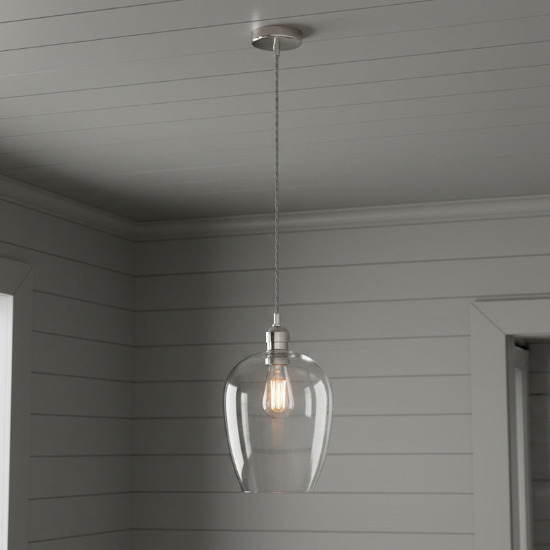 Tall clear glass pendant with nickel fitting and grey twisted flex. Over a kitchen island, in a hall or on a stairwell, very versatile lighting