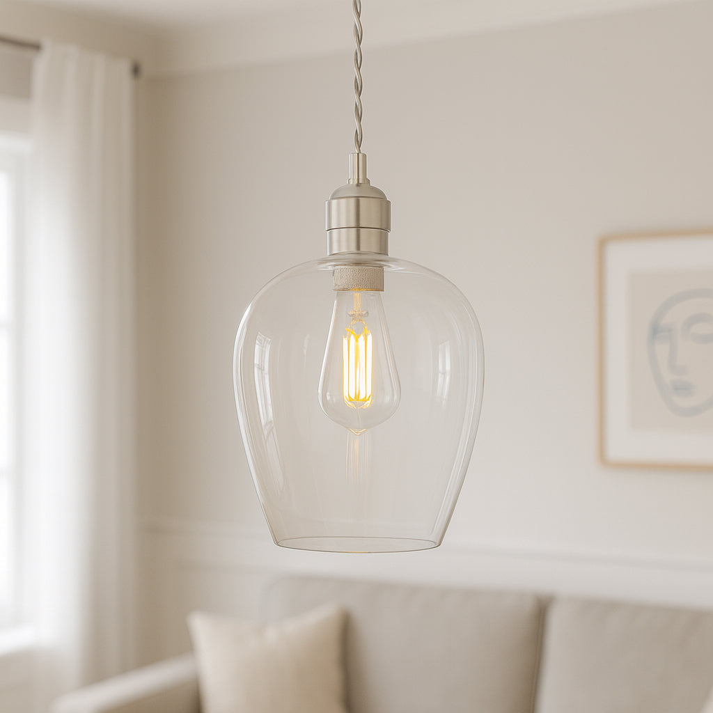 Tall clear glass pendant with nickel fitting and grey twisted flex. Over a kitchen island, in a hall or on a stairwell, very versatile lighting