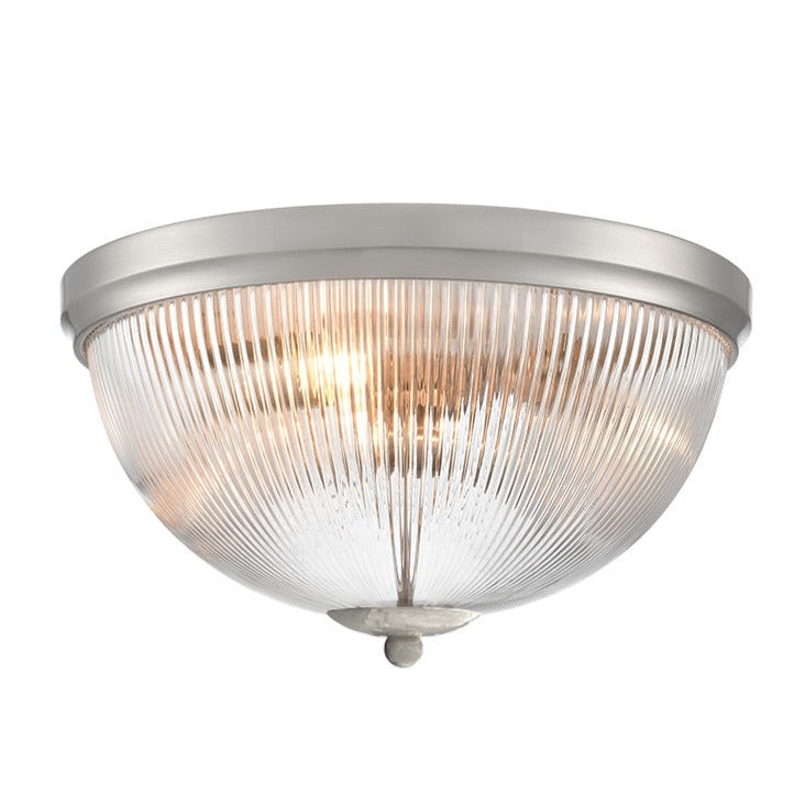 Ceiling light flush light with ribbed glass shade.