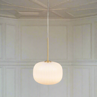 Milk glass ribbed round pendant. Perfect Kitchen Island Light . The opaque glass illuminated with an Led bulb giving a warm glow to any room.