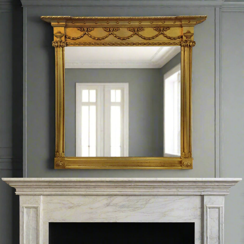 Our exquisite Ornate Giltwood Overmantle mirror is&nbsp; a breathtaking reproduction inspired by Victorian and Edwardian design. Measuring 120x120cm, this pale gilt-finished masterpiece adds a touch of grandeur to any space, whether perched above a marble fireplace in a city townhouse or gracing the walls of a countryside retreat.