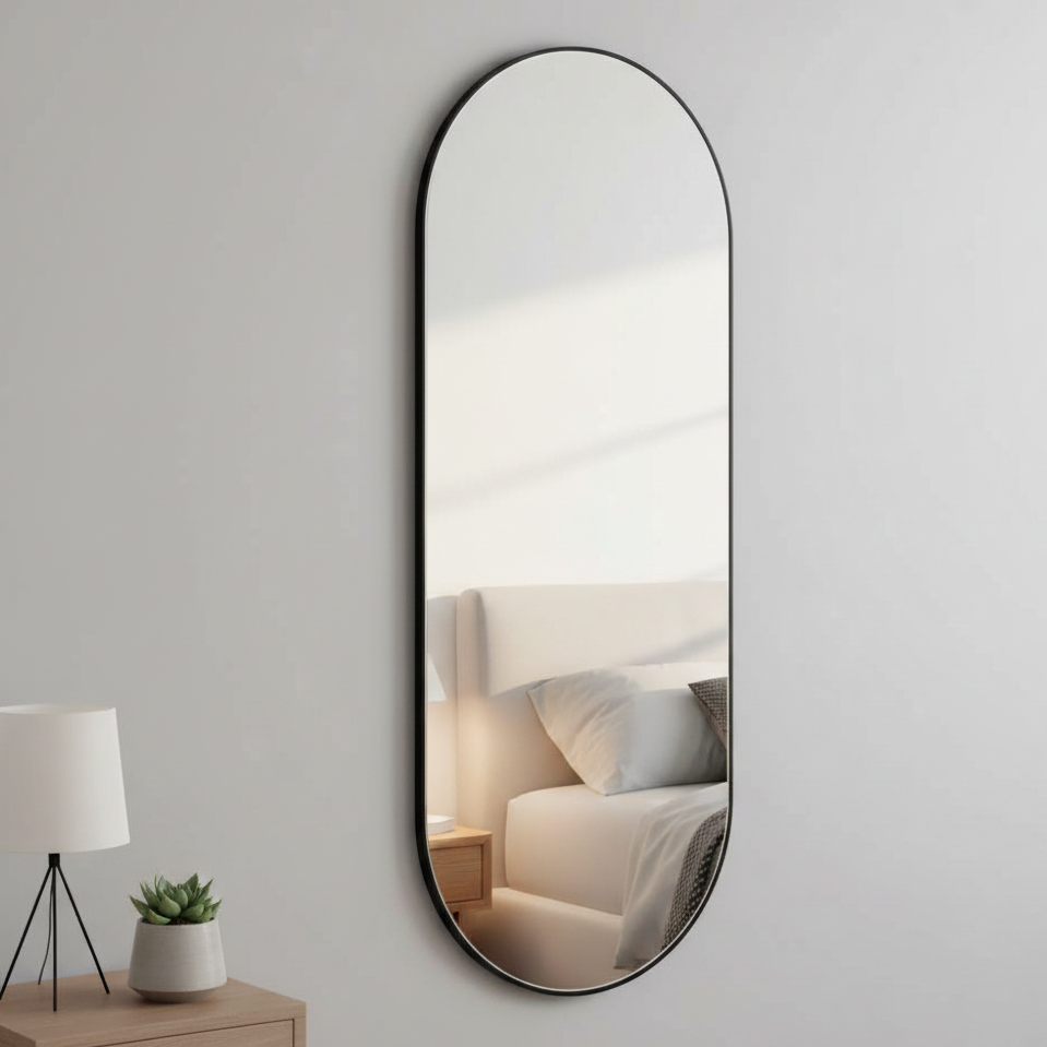 This tall oval mirror is enhanced by a minimal black metal frame, perfect for adding light to the darkest of spaces.