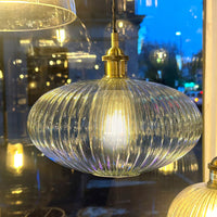 Ribbed glass and brass metal pendant light in an oval, pumpkin shape. Great over a kitchen island or anywhere in the kitchen.