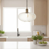 Ribbed glass and brass metal pendant light in an oval, pumpkin shape. Great over a kitchen island or anywhere in the kitchen.