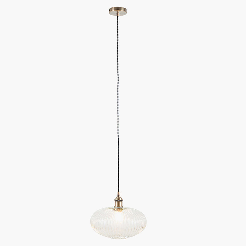 Ribbed glass and brass metal pendant light in an oval, pumpkin shape. Great over a kitchen island or anywhere in the kitchen.