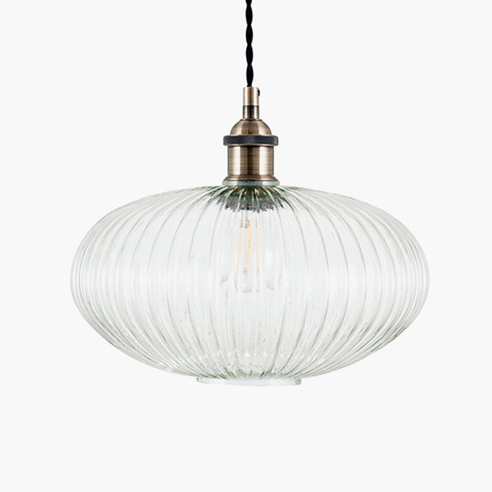 Ribbed glass and brass metal pendant light in an oval, pumpkin shape. Great over a kitchen island or anywhere in the kitchen.