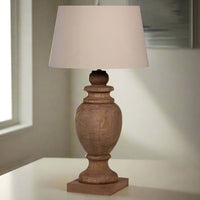 Stunning, exceptionally large wooden table lamp with neutral linen shade. The lamp in a natural wooden finish would look amazing in a hall or living room on a console or side table, The shade would throw light out into the room.&nbsp;


H: 95 cm W: 50 cm