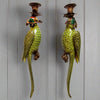 We now have our bronze and porcelain parrots as wall lights.&nbsp; These unusual candle holders would be a stunning focal point on any wall, comprising of bronze candle sconces linked to a scroll of bronze at the mouth of the parrot.&nbsp; The body of the parrot is stylised in a rich green glaze with feather detailing and elongated tails. They are exquisitely made and are an heirloom piece that will add luxury to your home.