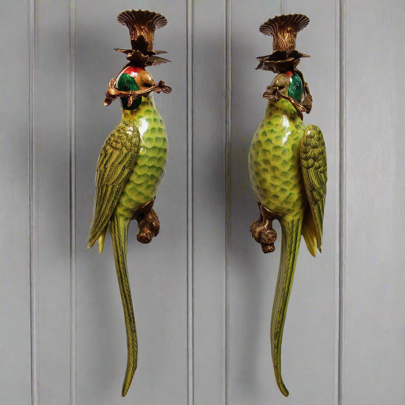 We now have our bronze and porcelain parrots as wall lights.&nbsp; These unusual candle holders would be a stunning focal point on any wall, comprising of bronze candle sconces linked to a scroll of bronze at the mouth of the parrot.&nbsp; The body of the parrot is stylised in a rich green glaze with feather detailing and elongated tails. They are exquisitely made and are an heirloom piece that will add luxury to your home.