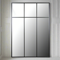Tall, black metal rectangular mirror with three squares to the top, a great window mirror. Perfect used outside or indoor. Always a great way to allow light and perspective into an industrial space. 
