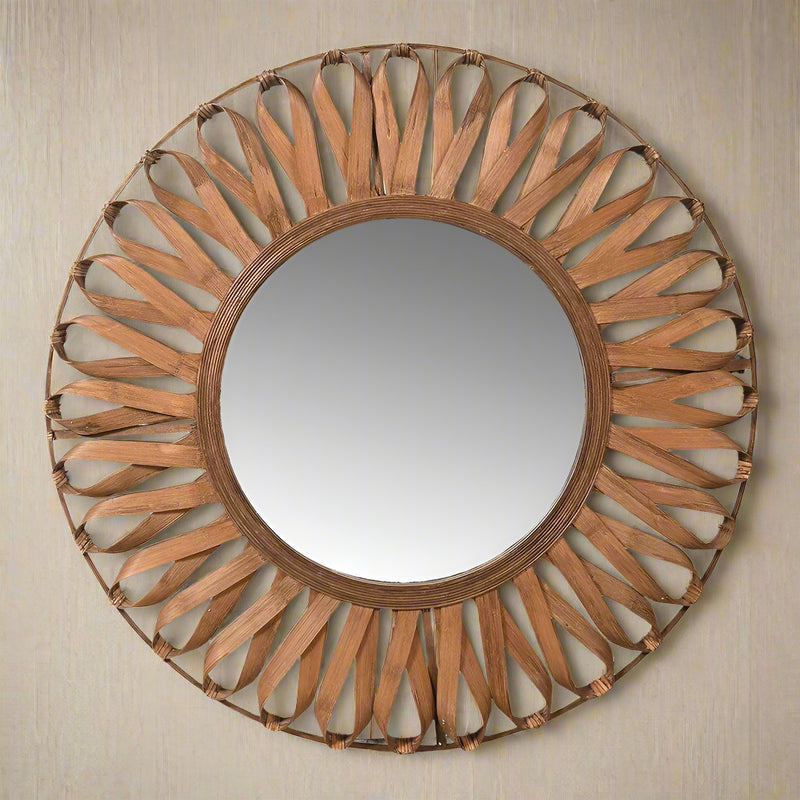 Round bamboo framed mirror in a ribbon pattern.&nbsp; The inner frame of the mirror is designed as a ribbon pattern.&nbsp; &nbsp;A great Scandi look, simple but effective with the looped, flexible bamboo strips sitting on a round frame.&nbsp; &nbsp;The warm honey coloured tone of the mirror enhances the light in any room.&nbsp; Whether this mirror is in a hallway, living room or bedroom it will certainly make a statement,