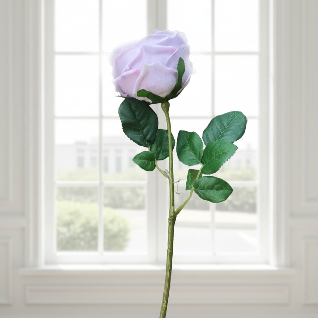 This ultra-realistic artificial lilac rose features rich, velvet-like petals and a vibrant green stem with textured leaves