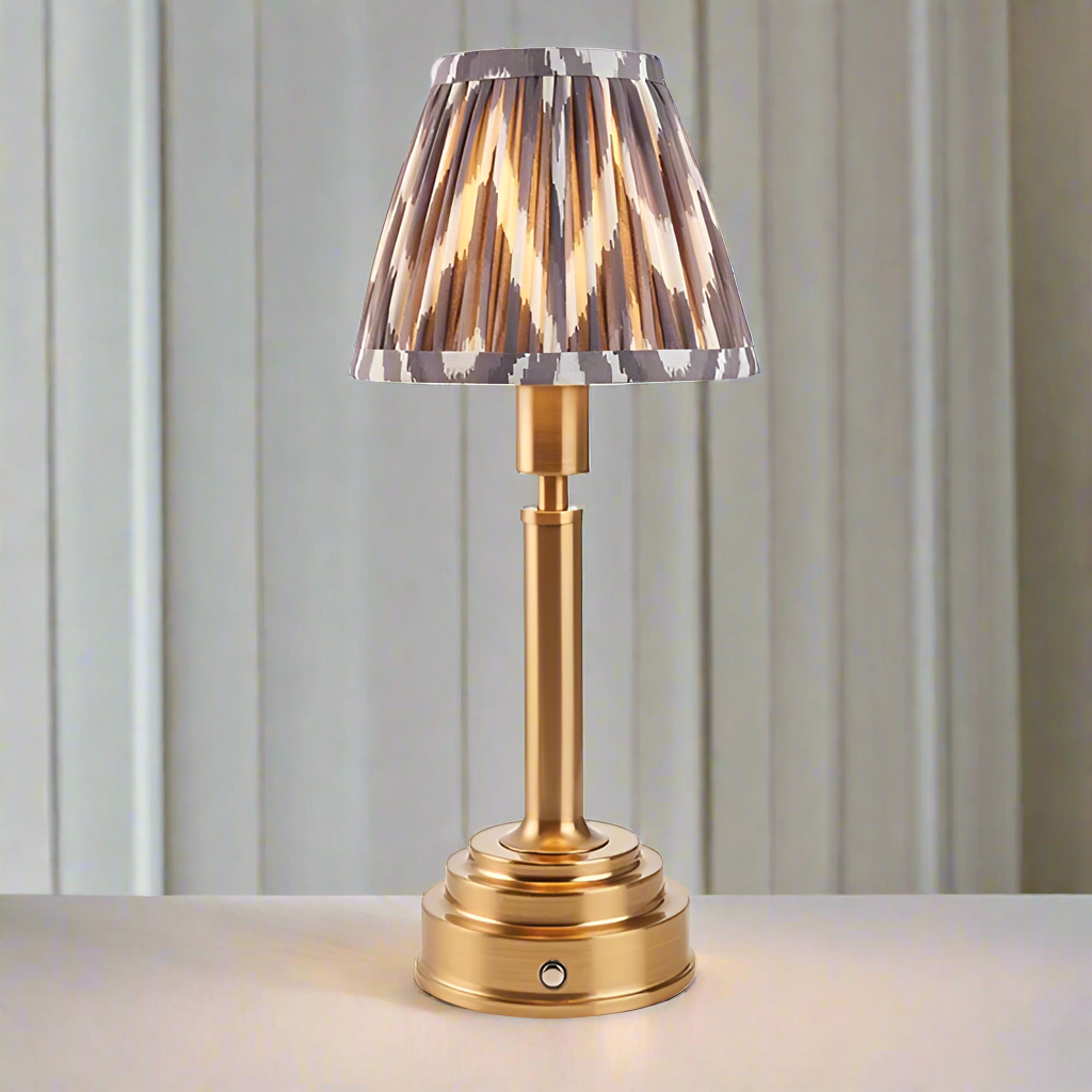 Brushed gold, rechargeable table lamp with a USB port. This portable, rechargeable 3 stage touch dimmer table lamp