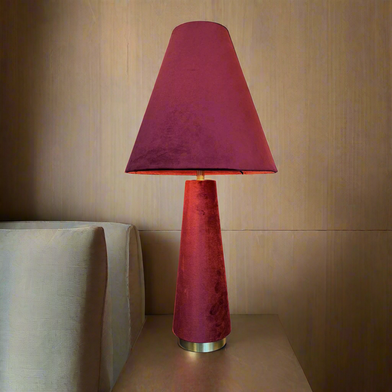 A stunning red velvet lamp and shade, an unusual but very tactile lamp made entirely of red velvet fabric.&nbsp; Perfect bedside lamp, the conical shade is placed onto an inverted conical base connected by an antique brass rod and antique brass base. The perfect way to add colour to a room, a pair of these vibrant lamps will create a warm glow to any interior.