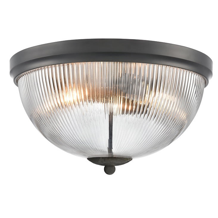 Flush ceiling light fixture with ribbed glass shade.