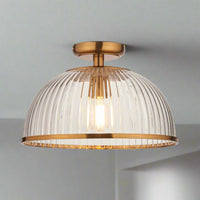 Illuminate your space with timeless elegance using this ribbed glass flush ceiling light with gilt metal detailing. Designed to combine classic sophistication with modern functionality,