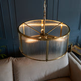 Antique gold, circular ribbed light. A dark gilt colour adds warmth to this 3 light pendant. Perfect hall or sitting room central light with glass ribbed panels. W: 45 cm H: 40 cm (Min) 176 cm (Max)