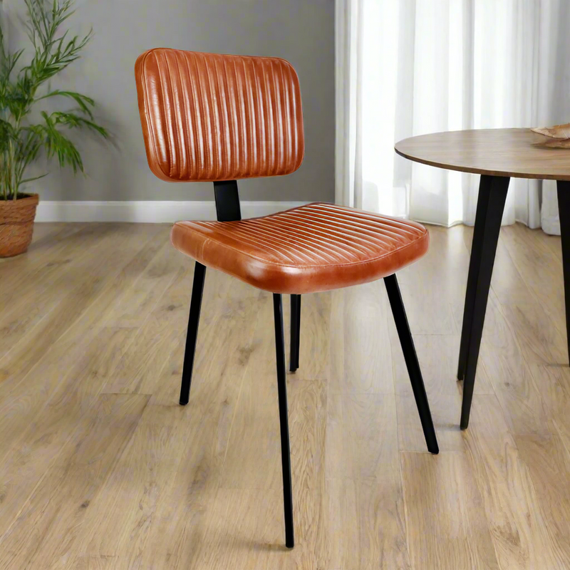 This ribbed dark leather dining chair hand is hand selected by Decorexi for it's vintage industrial style to service your dining or desk space at a totally affordable price.&nbsp;


Made from real leather, this dining or desk chair will transform your seating experience.&nbsp; Contemporary, slim iron legs make this a perfect fit for tables where you don't want the chair to over-dominate.