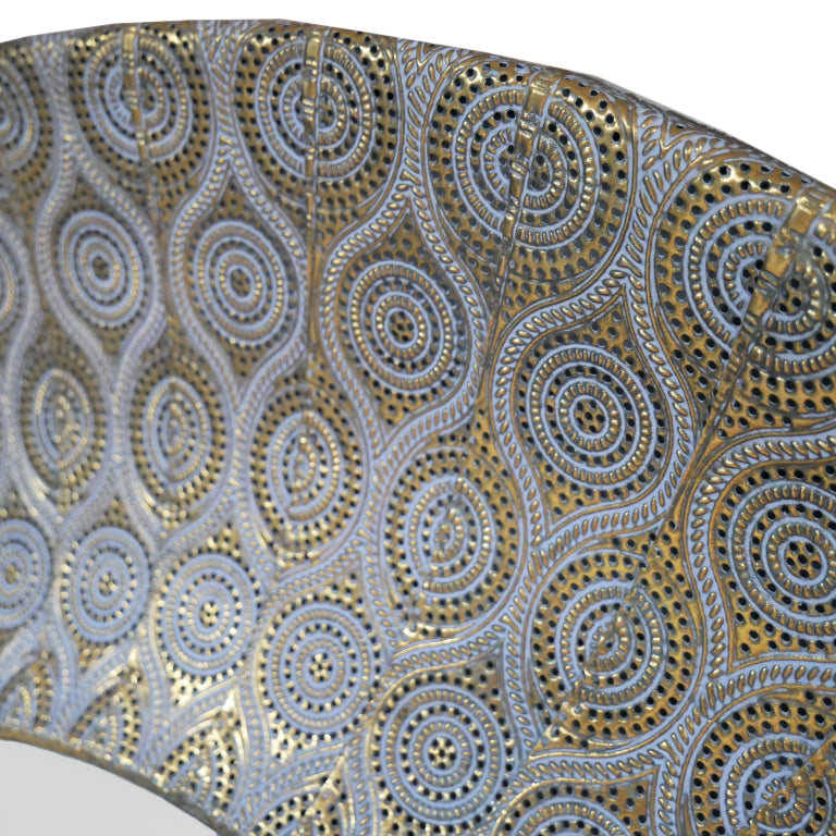 Round wall mirror with patterned moroccan design antique gold frame. Textured metallic finish adds warmth and depth to living rooms, bedrooms, or hallways.