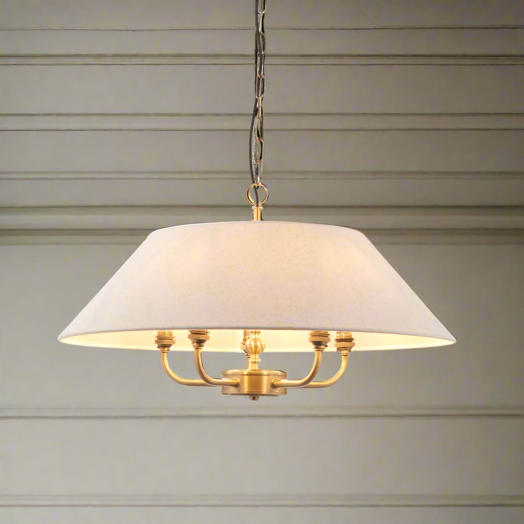 Classic shaded brushed gilt chandelier with 5 lights.&nbsp; An elegant easy way to spread light in your living room, over a dining table and an especially great light for a bedroom.&nbsp;&nbsp; The shade is a light coloured linen and the metal 5 arm light is a deep burnished, antique gold, the shade hanging from a gilt ring attached to a gilt chain.