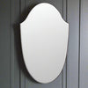 Large shaped mirror without a frame, this large mirror is shield shaped, without an outer frame to allow the mirror to disperse the light in any room without the restrictions of a frame. Perfect for a bathroom or dressing room, it would also work well in a living room or a hall, the full metre height flashing light from the wall.