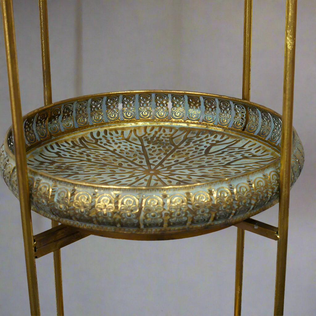Moroccan style three tier folding stand in antique brass with galleried trays.&nbsp; &nbsp;Can be used in a kitchen, bathroom, anywhere in the house to display or use as extra storage. A great, authentic Moroccan look that works well in a period or eclectic interior.&nbsp; In a conservatory or on a patio covered in plants, bathroom for all those bathing accessories, this unit has so many uses.