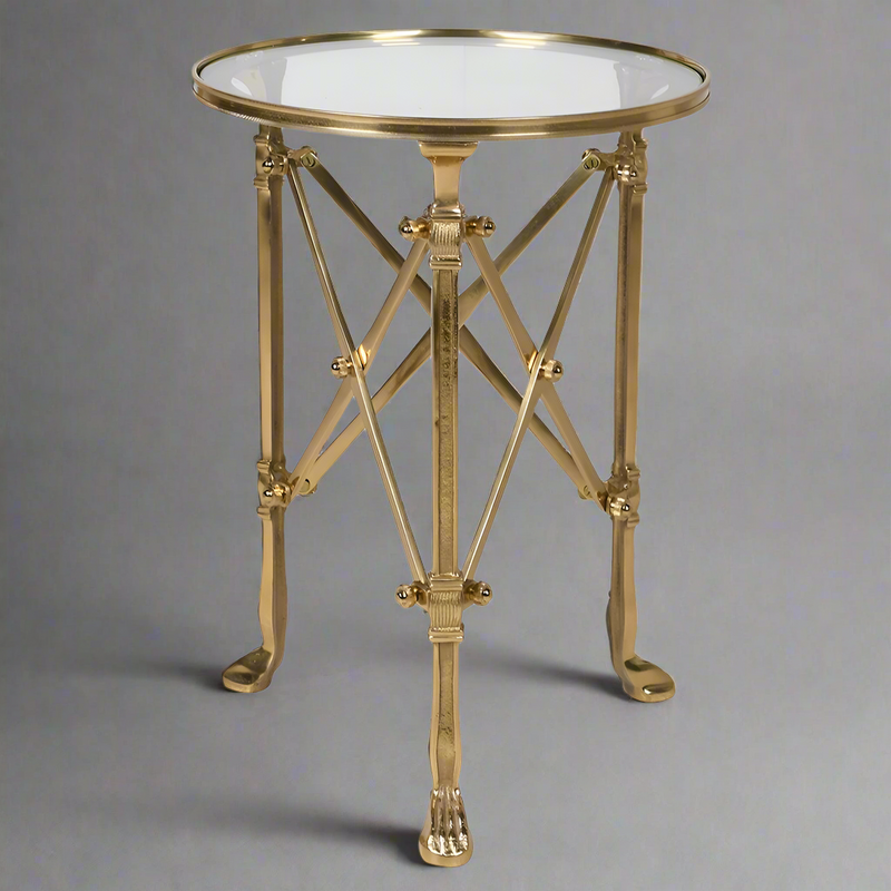 Antique brass and glass occasional table with multi support legs and struts. A really stunning statement side table that will add a lot of style to your sitting room.The main support of 3 antique brass footed legs is complimented by cross braces to give an architectural look. 

