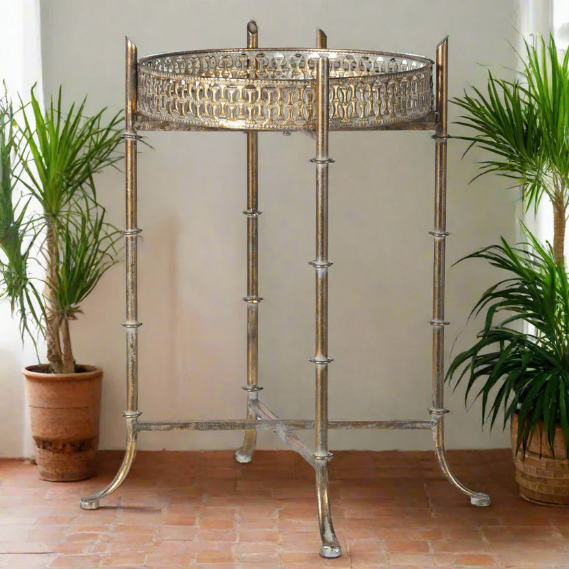 This small tray table is small and exceptionally versatile.&nbsp; The round mirrored tray with ornate detailing lifts up and can be used as a portable tray.&nbsp; The legs can then be folded flat and put away when not in use.&nbsp;

Overall, a small and incredibly useful side table and surface area on which you can place a lamp, drinking glasses, or anything else desired.&nbsp; At only 33cm wide, this tiny elegant table and tray will fit into any space.