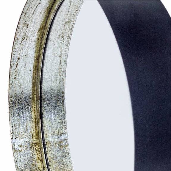 Close-up of a silver round mirror with a deep pewter metal frame and black accents, showcasing its recessed design for a modern decor element.