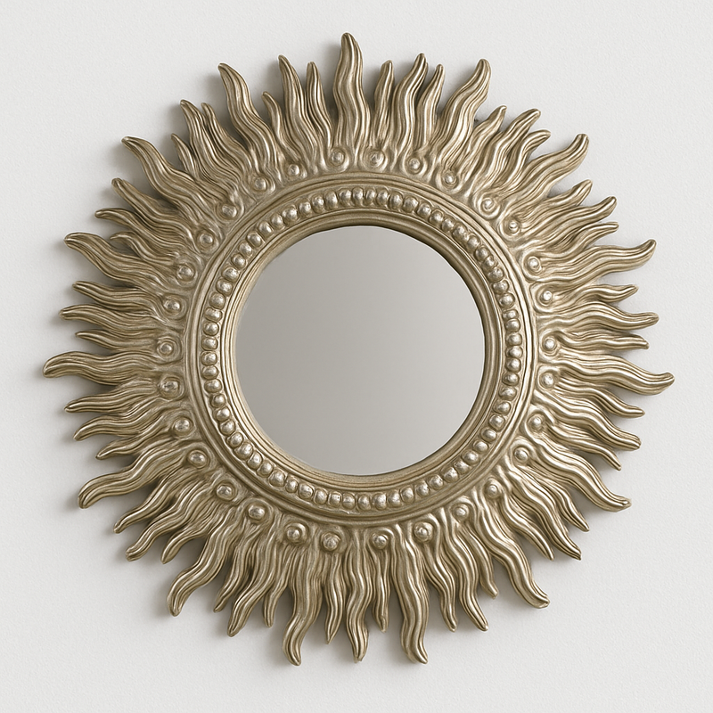 Decorative sun-shaped mirror with a gold finish on a white background