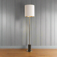 Very tall, simple, slim profile antique brass floor lamp se in a black marble base. This is the floor lamp you need in an uncluttered space, the tall white shade adding a glow from a gold inner sat on a very slim pole and marble base. Stunning in a corner of your home.&nbsp;