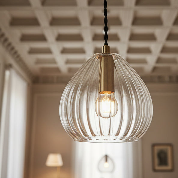 A beautifully simplistic and understated brushed brass glass pendant with ribbed detailing.  16 cm
