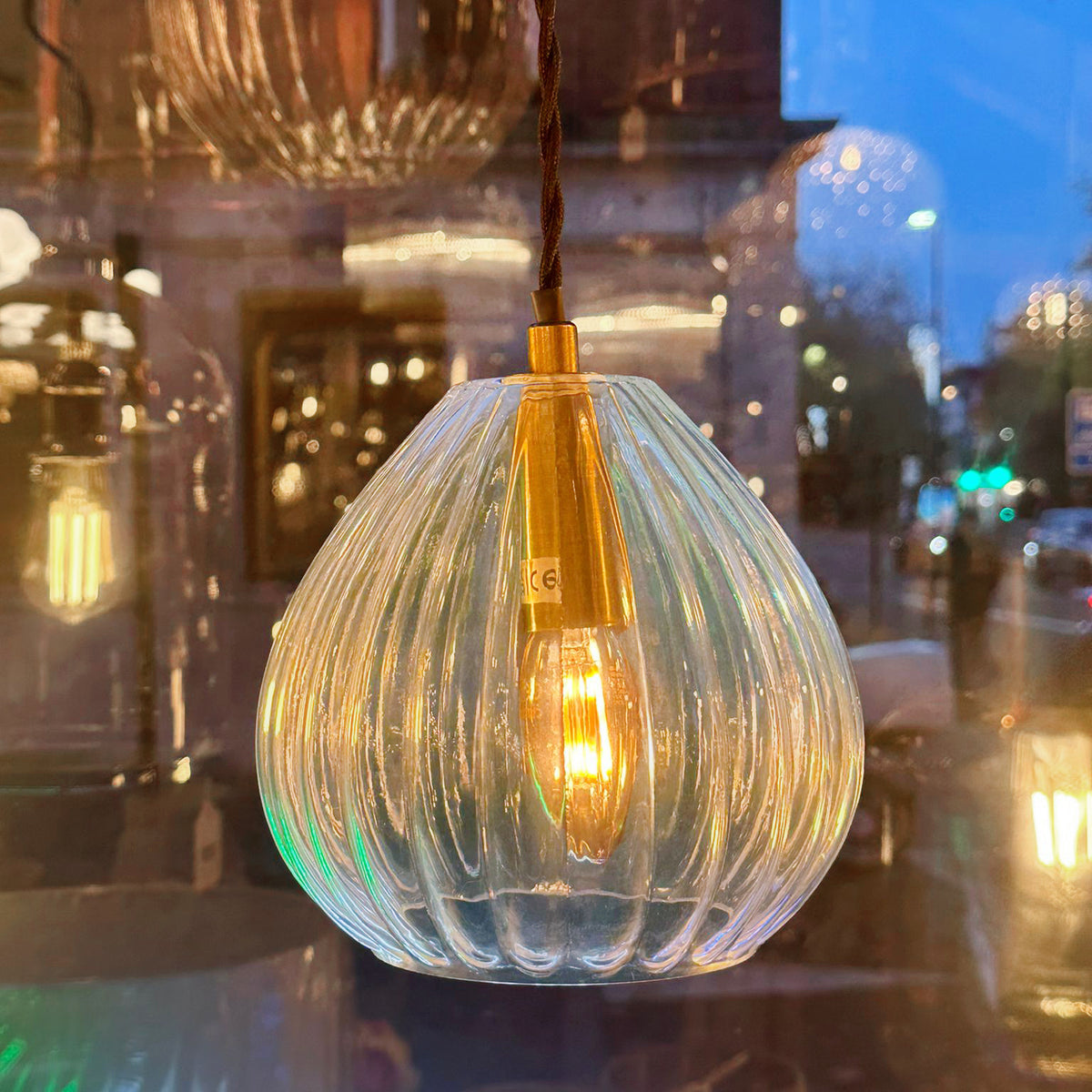 A beautifully simplistic and understated brushed brass glass pendant with ribbed detailing.  16 cm