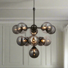 The scale of this 11 ball light makes a huge statement in any room, the matt metalwork and the smoked glass on the globe lights add sophistication and glamour.
