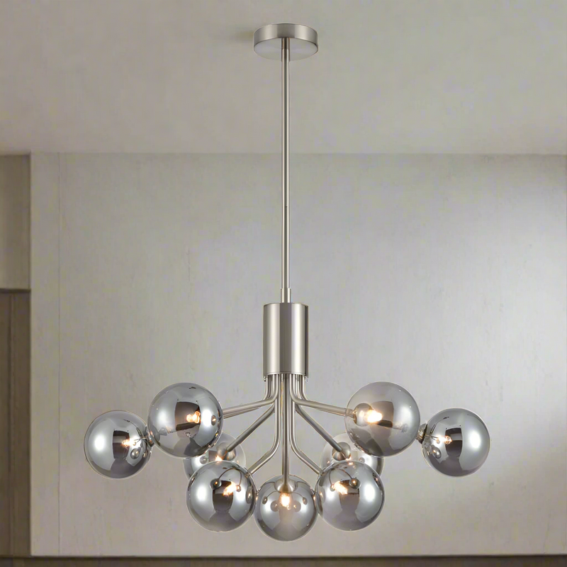 A stunning statement light that diffuses ample light around your home.&nbsp; Nine smoked glass shades are suspended from beautiful satin nickel metal arms that are seamlessly attached to an adjustable or extendable brass rod. 