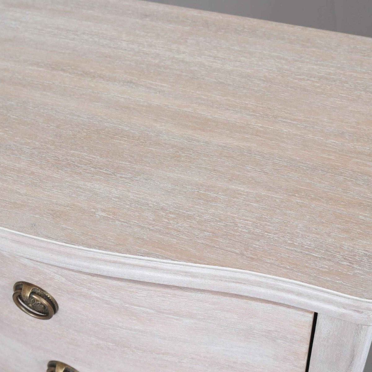 Top view of Wooden Five Drawer Tallboy in soft off white finish, showcasing curved edge design and lime wash texture for bedroom storage.