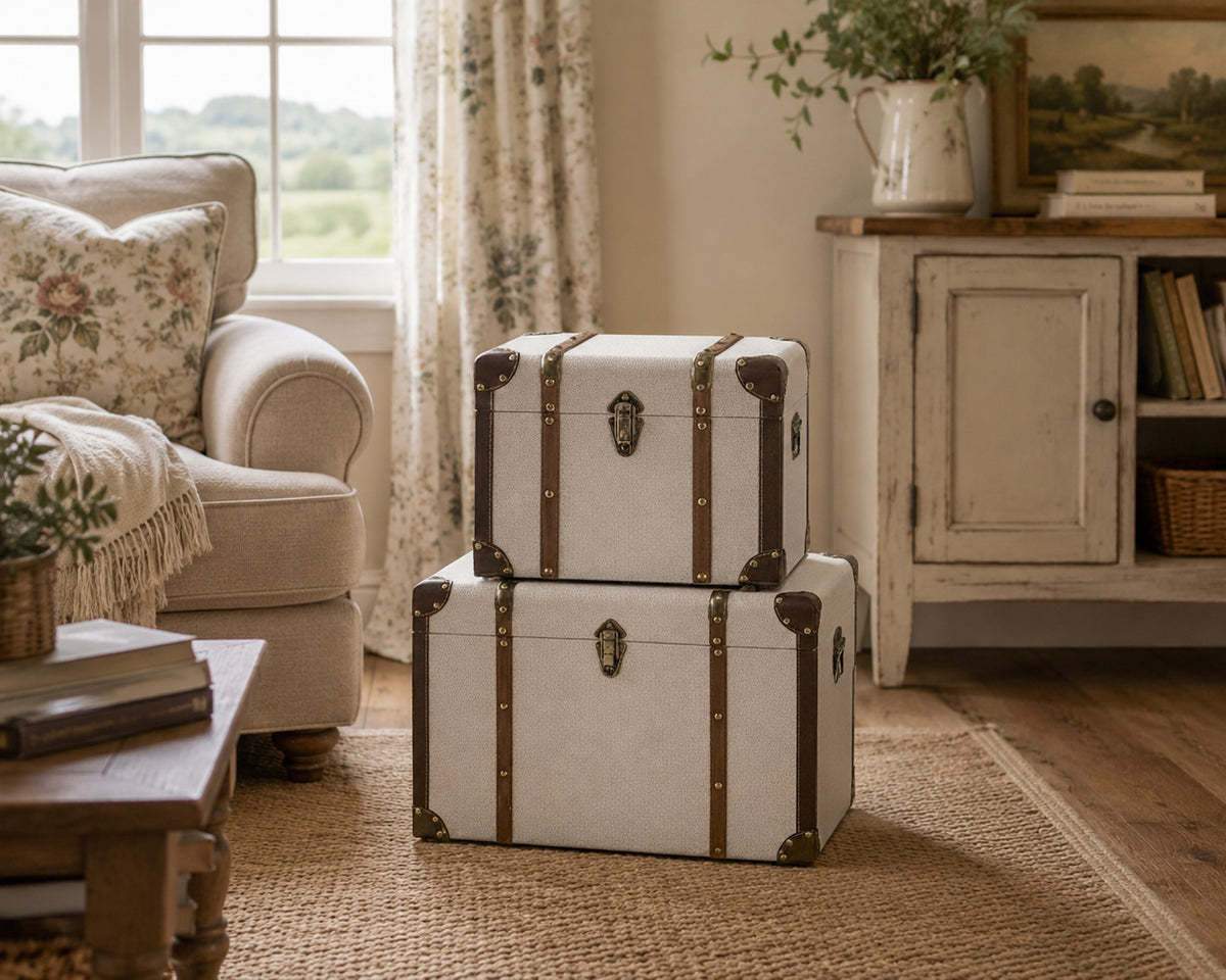 a pair of cream storage trunks in a living room
