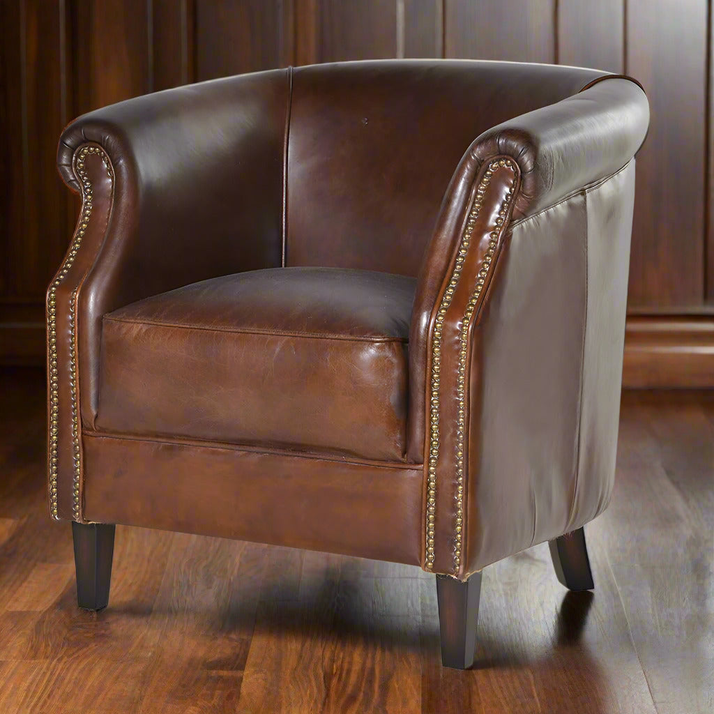 Luxurious leather chair in a deep mahogany colour.&nbsp; &nbsp;A typical 'gentlemen's club' armchair with brass studding and wooden feet.&nbsp; This chair is full of vintage charm, so comfortable with a thick, well padded seat and low, curved back.&nbsp; The brass studding all the way up the sides adds to the traditional appeal.&nbsp; Overall, a beautifully crafted, luxurious armchair which would lift the aesthetic appeal of any room, library, study or living room.

H: 82 cm&nbsp; W: 85 cm D: 85 cm&nbsp;