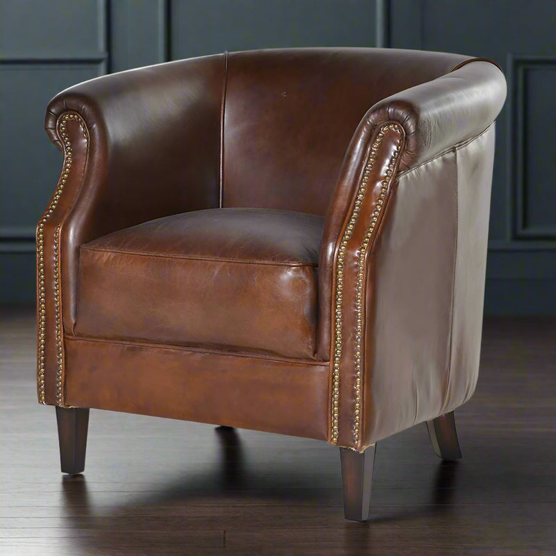 Luxurious leather chair in a deep mahogany colour.&nbsp; &nbsp;A typical 'gentlemen's club' armchair with brass studding and wooden feet.&nbsp; This chair is full of vintage charm, so comfortable with a thick, well padded seat and low, curved back.&nbsp; The brass studding all the way up the sides adds to the traditional appeal.&nbsp; Overall, a beautifully crafted, luxurious armchair which would lift the aesthetic appeal of any room, library, study or living room.

H: 82 cm&nbsp; W: 85 cm D: 85 cm&nbsp;