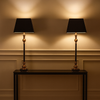 Bring timeless sophistication into your home with this tall black and gilt lamp, designed to make a statement in any room. Featuring a sleek black base accented with warm antique gold detailing, this lamp perfectly balances modern elegance with traditional charm. The structured black shade softens the glow, creating ambient lighting ideal for living rooms, bedrooms, or entryways.

Crafted for both style and function, this decorative table lamp adds height, drama, and a touch of luxury to side tables, consol