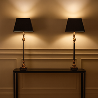 Bring timeless sophistication into your home with this tall black and gilt lamp, designed to make a statement in any room. Featuring a sleek black base accented with warm antique gold detailing, this lamp perfectly balances modern elegance with traditional charm. The structured black shade softens the glow, creating ambient lighting ideal for living rooms, bedrooms, or entryways.

Crafted for both style and function, this decorative table lamp adds height, drama, and a touch of luxury to side tables, consol