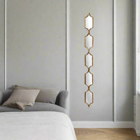 A very tall and narrow mirror perfect for any space in need of glamour, in a bedroom