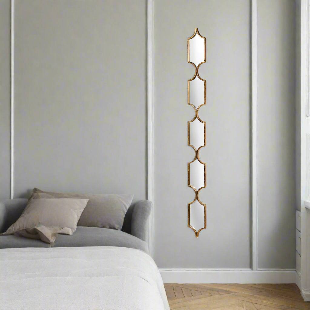 A very tall and narrow mirror perfect for any space in need of glamour, in a bedroom